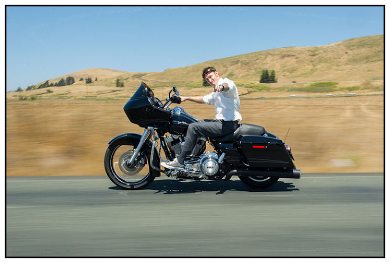 Groom riding Harley Davidson Motorcycle to his wedding